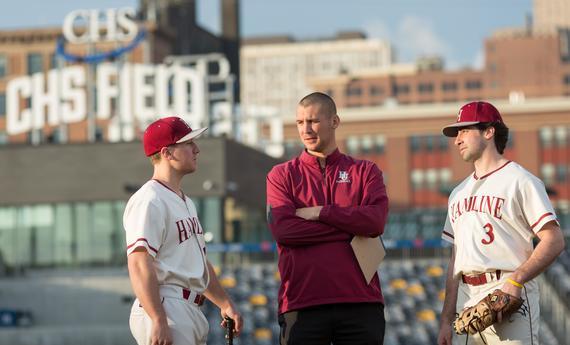 Two  Undergraduate Students Athletics with a coach on CHS Field 