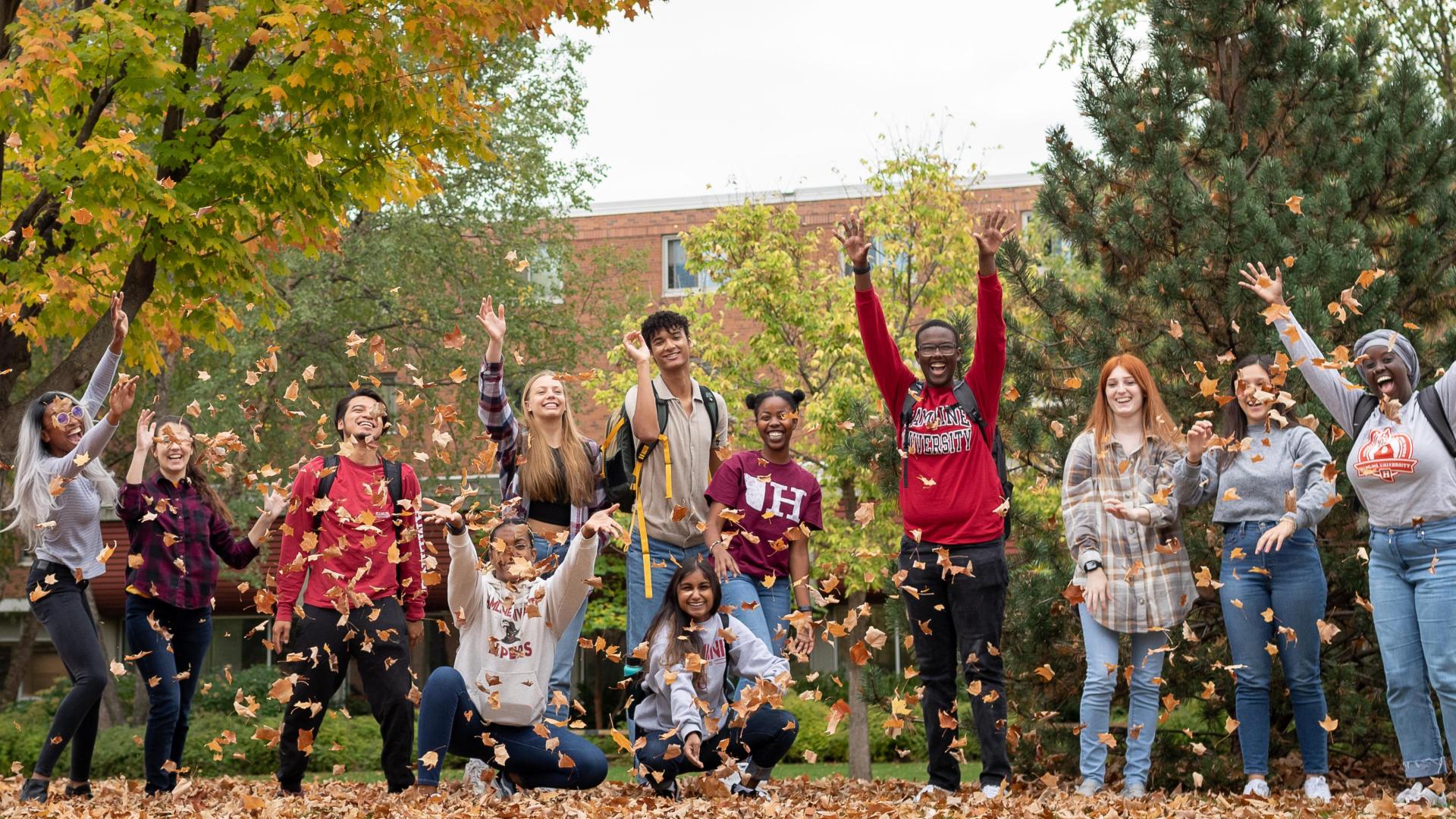   happy students at  during the fall blowing the leafs